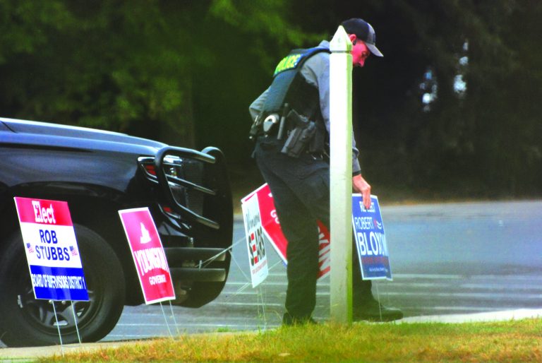 Uniformed Eastville Officer Spotted Placing Campaign Signs